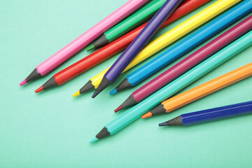 Obraz premium Color pencils on mint background. Space for text