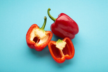 Red sweet pepper on blue background. Space for text. Flat lay. Vertical photo