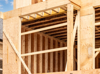 Detail of a wood stud wall showing the studs and plywood sheathing in residential construction

