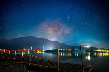 Beautiful view of the Milky Way from the pier on the lakeside of the mountains. Sun Moon Lake is one of Taiwan's famous tourist attractions. Nantou county.