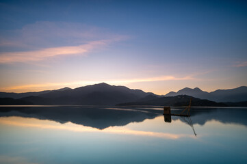 Before sunrise, the view of the dock with lakes and mountains. Sun Moon Lake is one of Taiwan's famous tourist attractions. Nantou county.