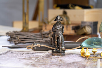 Bronze statuette of Napoleon Bonaparte I standing on a map. Close-up.