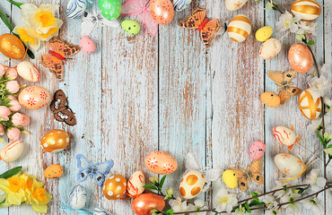 Composition with decorated Easter eggs, butterflies and apple tree branches. Happy Easter concept,...