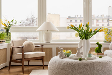 Interior design of spring living room with design sofa, furniture, vase with tulips, easter...