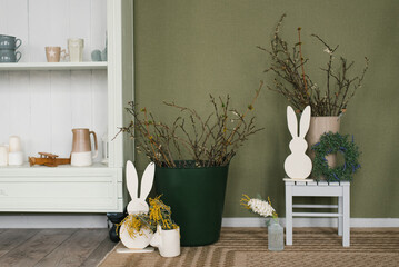 Green room with a white wall and a green plant mimosa, figure rabbit for Easter