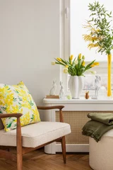 Fotobehang Interior design of spring living room with design armchair, furniture, vase with flowers, easter decorations and elegant accessories. Home decor. Template. Easter holidays.  © FollowTheFlow