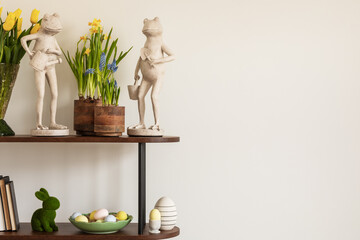 Easter compositions in stylish living room space with wooden shelf, beautiful decorations and...