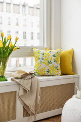 Easter compositions in stylish living room space with wooden windows sill, beautiful decorations, flowers, tulips and elegant accessories. Template. Easter holidays.	
