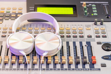 white headphone on audio mixing console. music background, recording concept - 752438000