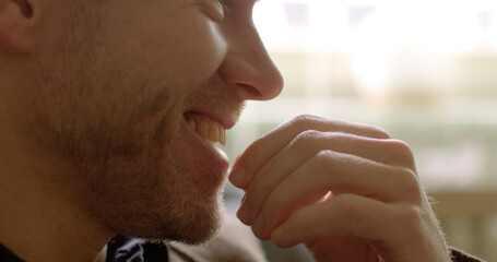 Man actively engaged in conversation or dialogue. Whether discussing ideas, sharing thoughts, expressing joyful emotions. Close-up portrait of man hands and smiling laughs face.  - obrazy, fototapety, plakaty
