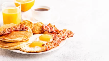 Fotobehang Healthy Full American Breakfast with Eggs Bacon Pancakes and Latkes. © tbralnina