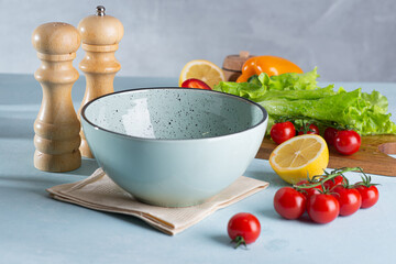 Kitchen table with vegetables and herbs and ceramic pottery