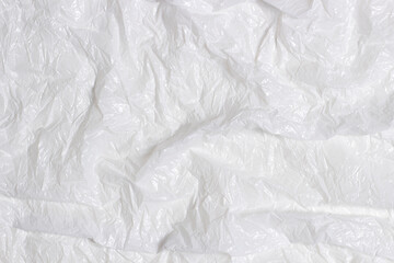 Abstract background of white plastic wrap material. Crumpled wrinkled plastic cellophane....