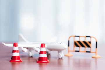 Traffic cones and toy airplane on wooden table with copyspace