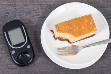 Glucometer and sweet cheesecake. Measuring and sugar level control during diabetes