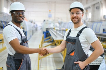 Obraz premium Two Heavy Industry Engineers Stand in Factory