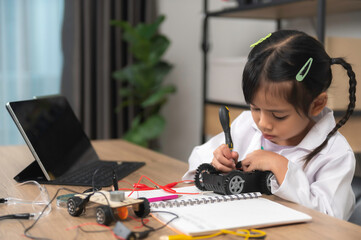 Asian littlle girl constructing and coding robot at STEM class,Fixing and repair mechanic toy car
