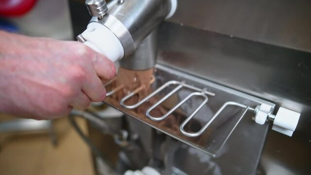 man pouring ice cream after pasteurization into the freezer, ice cream manufacture concept. High quality 4k footage