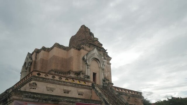 view to ancient ruin pagoda building of Chedi Luang temple in city center of Chiangmai in Thailand under cloudy day time