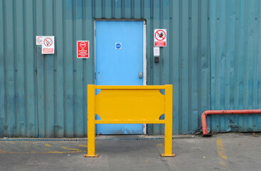 Emergency Exit and Yellow Safety Fence in Old Metal Industrial Building 