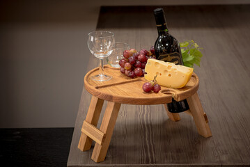Wooden table for serving wine and fruit. Festive dinner with wine.