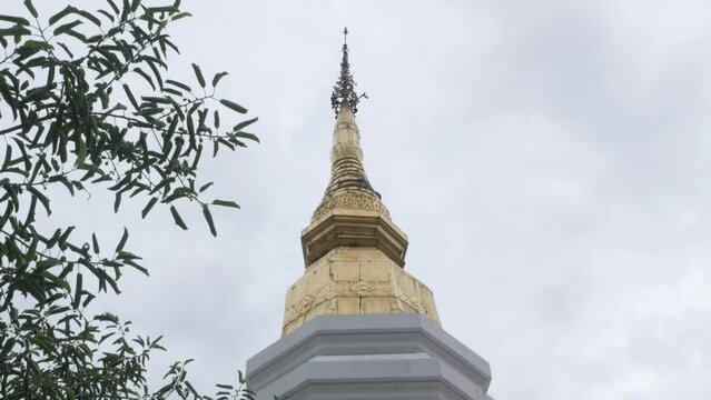 look up view to the golden beautiful pagoda against cloudy sky in Chiangmai Thailand with northern ancient design architecture
