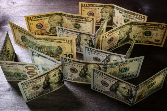 American dollar bills on a dark table. Unusual angle.