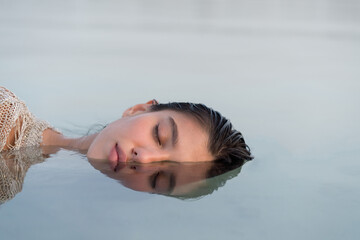 Portrait of the Beautiful woman with her face partially  submerged in water
