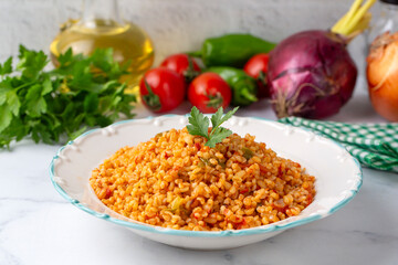 Traditional turkish bulgur pilaf with tomato sause in plate (Turkish name; meyhane pilavi)