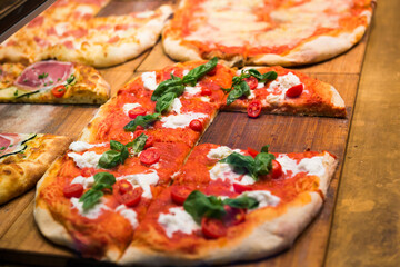 Many slices of pizza on wooden table in restaurant - 752469032