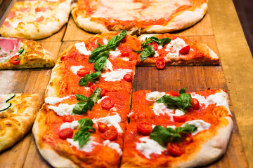 Many slices of pizza on wooden table in restaurant - 752469034
