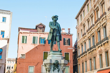 Monument of Carlo Goldoni at square with old buildings in Venice, Italy