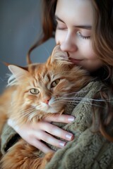 young woman holding a cat orange colour