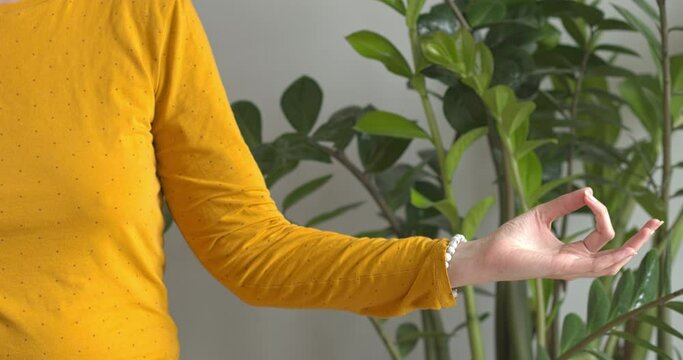 Woman doing gyan mudra hand meditation gesture.