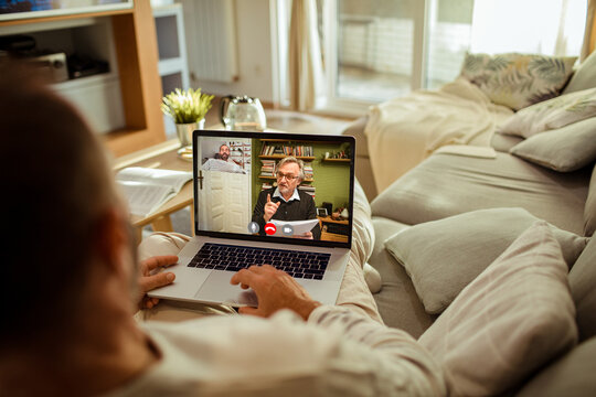 Man having video call with financial advisor from home