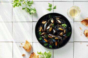 Mussels ready to eat standing on a tile kitchen surface