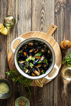 Mussels in a pot culinary concept, top down view