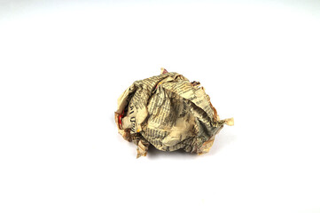 A screwed up piece of newspaper over a white background.