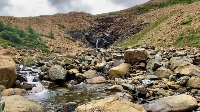 Tablelands in Gros Morne National Park, a Canadian national park and World Heritage Site in Newfoundland. An area where earth's mantle is exposed, peridotite rocks rich with iron rust, waterfall.