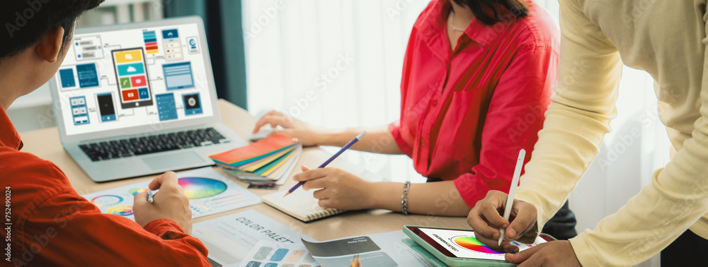 Poster cropped image of interior designer team presents color by using color swatches while laptop displaye