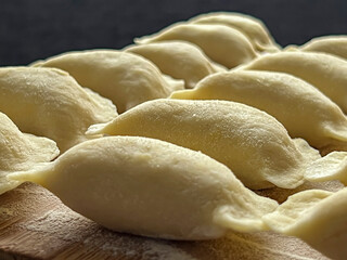 Home-made dumplings, kneading the dough by hand, rolling it, cutting it out and gluing it together