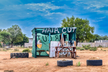 shack for a barber shop in south africa on the side of the road, no people
