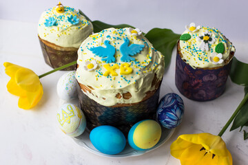 Easter card. Top view of Easter cake, eggs and yellow tulips