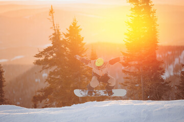 Freeride snowboarder jumping extreme winter sports on background snowy forest, Sheregesh ski...