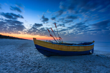 Fishing boats on the Baltic Sea beach in Jantar at sunset. Poland