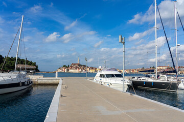 nice view of the sunny city of Rovinj with the adriatic sea from a pier with sail boats