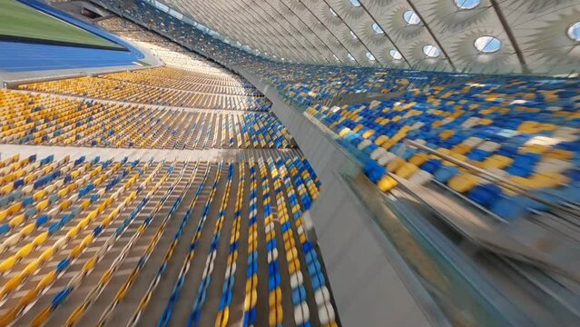 FPV flight, Stadium. cityscape time of day night. The view from the top to the illuminated stadium with games and fans. Stadium, Kiev, Ukraine, Soccer stadium field, soccer background, outdoor sport 