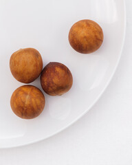 Avocado seeds on a white plate showcasing symmetry and contrast