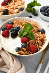 Breakfast with yogurt cereals and berries. - 752522084