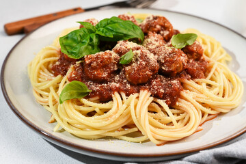 Pasta in tomato sauce with meat balls and a glass of wine.